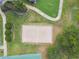 Aerial view of sand volleyball court, and lush landscaping at 848 Magnolia Creek Cir, Orlando, FL 32828