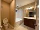 Well-lit bathroom featuring a vanity with storage and a shower-tub combination at 8608 Falstaff Pl, Oviedo, FL 32765