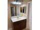 Bathroom vanity with a big mirror and a view into another room at 8608 Falstaff Pl, Oviedo, FL 32765