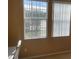 Bedroom with beige walls, carpet, and windows with white vertical blinds at 8608 Falstaff Pl, Oviedo, FL 32765