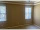 Bedroom with neutral walls, carpet, and two bright windows at 8608 Falstaff Pl, Oviedo, FL 32765