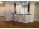 Kitchen featuring breakfast bar, wood floors and white cabinets at 8608 Falstaff Pl, Oviedo, FL 32765