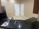 Kitchen featuring dark granite countertops, a stainless steel sink, and bright tile floors at 8608 Falstaff Pl, Oviedo, FL 32765