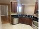 Gourmet kitchen featuring stainless steel appliances, dark granite countertops, and wood cabinetry at 8608 Falstaff Pl, Oviedo, FL 32765