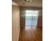 Bright, modern living room with hardwood floors and sliding doors to the backyard at 8608 Falstaff Pl, Oviedo, FL 32765