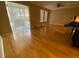 Bright living room featuring hardwood floors, ceiling fan and a sliding glass door to the outside at 8608 Falstaff Pl, Oviedo, FL 32765
