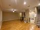 Spacious living room with hardwood floors, a ceiling fan, and an open view of the kitchen at 8608 Falstaff Pl, Oviedo, FL 32765