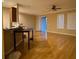 Open living room featuring hardwood floors, bright windows, and a sliding door to the backyard at 8608 Falstaff Pl, Oviedo, FL 32765