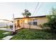 Home's backyard features a cozy patio area with outdoor seating and string lights at 920 Timor Ave, Orlando, FL 32804