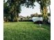 Home's expansive backyard is surrounded by a large shade tree and a privacy fence at 920 Timor Ave, Orlando, FL 32804