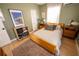 Bright bedroom features wood floors, olive green walls, and a cozy area rug at 920 Timor Ave, Orlando, FL 32804