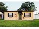 Charming single-story home featuring a well-maintained lawn and dark shutters at 920 Timor Ave, Orlando, FL 32804
