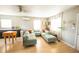 Open-concept living area with light wood floors, a large sofa, and bright windows at 920 Timor Ave, Orlando, FL 32804
