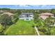Stunning aerial view of a luxury home featuring a pool and sprawling green lawn at 9259 Tibet Pointe Cir, Windermere, FL 34786