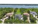 Aerial view displaying an exquisite home near a lake, surrounded by beautiful trees and well-kept grounds at 9259 Tibet Pointe Cir, Windermere, FL 34786