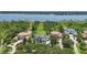 A stunning aerial view showing an estate home with private docks and access to a serene lake at 9259 Tibet Pointe Cir, Windermere, FL 34786