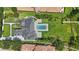 An aerial view of an estate with a pool, an outdoor kitchen and a sprawling manicured lawn at 9259 Tibet Pointe Cir, Windermere, FL 34786