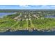 Wide aerial perspective of luxury homes on a waterfront property, featuring private docks and stunning views at 9259 Tibet Pointe Cir, Windermere, FL 34786