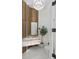 Modern powder room features a unique stone vanity, wood accent wall, designer lighting, and stylish fixtures at 9259 Tibet Pointe Cir, Windermere, FL 34786