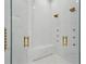 Shower featuring marble walls, gold hardware, and rain shower heads at 9259 Tibet Pointe Cir, Windermere, FL 34786