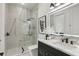Modern bathroom featuring a glass shower, marble vanity, and backlit mirror at 9259 Tibet Pointe Cir, Windermere, FL 34786
