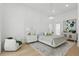 Airy bedroom featuring a modern chandelier, neutral decor, and ample natural light at 9259 Tibet Pointe Cir, Windermere, FL 34786