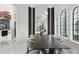 Contemporary dining room featuring modern lighting fixtures, dark wood table, and neutral decor for sophisticated gatherings at 9259 Tibet Pointe Cir, Windermere, FL 34786