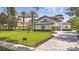 Expansive front yard and landscaping surround this home with a paved driveway leading up to a pristine residence at 9259 Tibet Pointe Cir, Windermere, FL 34786