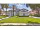 Beautiful exterior showcasing a well-manicured lawn, elegant landscaping, and the home's architectural design at 9259 Tibet Pointe Cir, Windermere, FL 34786