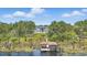 Waterfront home featuring a private dock surrounded by lush greenery and scenic views at 9259 Tibet Pointe Cir, Windermere, FL 34786