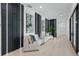 Contemporary hallway with sleek black accent walls, artwork, and designer sofa at 9259 Tibet Pointe Cir, Windermere, FL 34786