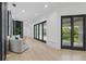 Bright hallway with glass doors leading to a balcony offering natural light and views at 9259 Tibet Pointe Cir, Windermere, FL 34786