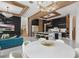 Open-concept kitchen with black cabinets, marble islands with seating, and modern lighting fixtures above a dining table at 9259 Tibet Pointe Cir, Windermere, FL 34786