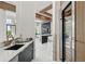 Contemporary kitchen with marble countertops, sleek cabinetry, designer fixtures, and a glimpse into the adjoining living space at 9259 Tibet Pointe Cir, Windermere, FL 34786