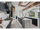 Bright, modern kitchen featuring marble islands, sleek black cabinetry, and stainless steel appliances, with a dining area nearby at 9259 Tibet Pointe Cir, Windermere, FL 34786