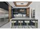 Contemporary kitchen with marble island, black cabinets with stainless steel appliances, and modern decorative lighting at 9259 Tibet Pointe Cir, Windermere, FL 34786