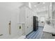Unique laundry room with blue patterned tile flooring, white cabinetry, and modern appliances at 9259 Tibet Pointe Cir, Windermere, FL 34786