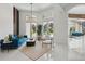 Bright living room with stylish furniture, white tile floors, and natural light streaming in through expansive doors at 9259 Tibet Pointe Cir, Windermere, FL 34786