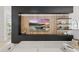 Modern living room featuring a sleek entertainment center with wood paneling and display shelves at 9259 Tibet Pointe Cir, Windermere, FL 34786