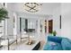 Open-concept living area with elegant lighting, stylish furnishings, and a seamless flow into the dining space at 9259 Tibet Pointe Cir, Windermere, FL 34786