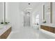 Bright, open bathroom boasts dual vanities, freestanding tub, and a glass-enclosed shower at 9259 Tibet Pointe Cir, Windermere, FL 34786