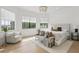 Bright main bedroom featuring a chandelier, accent chair, and views from two large windows at 9259 Tibet Pointe Cir, Windermere, FL 34786
