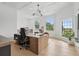 Bright home office featuring coffered ceilings, large windows, and a spacious wooden desk at 9259 Tibet Pointe Cir, Windermere, FL 34786