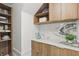 Organized pantry with wooden shelves, marble counters, and modern appliances for preparing food at 9259 Tibet Pointe Cir, Windermere, FL 34786