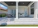 A covered patio with outdoor dining, a built-in BBQ, and steps leading to a well-manicured lawn at 9259 Tibet Pointe Cir, Windermere, FL 34786