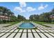 A beautiful in-ground pool surrounded by lush landscaping and a large grassy yard at 9259 Tibet Pointe Cir, Windermere, FL 34786
