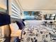 A coastal-themed bedroom with nautical decor, bright lighting, and a modern entertainment center at 935 S Atlantic Ave # 244, Daytona Beach, FL 32118