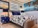 Bright bedroom featuring nautical décor, wood floors, lamps, and a calming ocean view mural at 935 S Atlantic Ave # 244, Daytona Beach, FL 32118