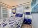 A bedroom with nautical themed bedding, window and decor in a brightly lit space at 935 S Atlantic Ave # 244, Daytona Beach, FL 32118