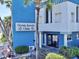 Attractive view of Ocean Jewels Club building, featuring a vibrant blue facade and lush landscaping at 935 S Atlantic Ave # 244, Daytona Beach, FL 32118
